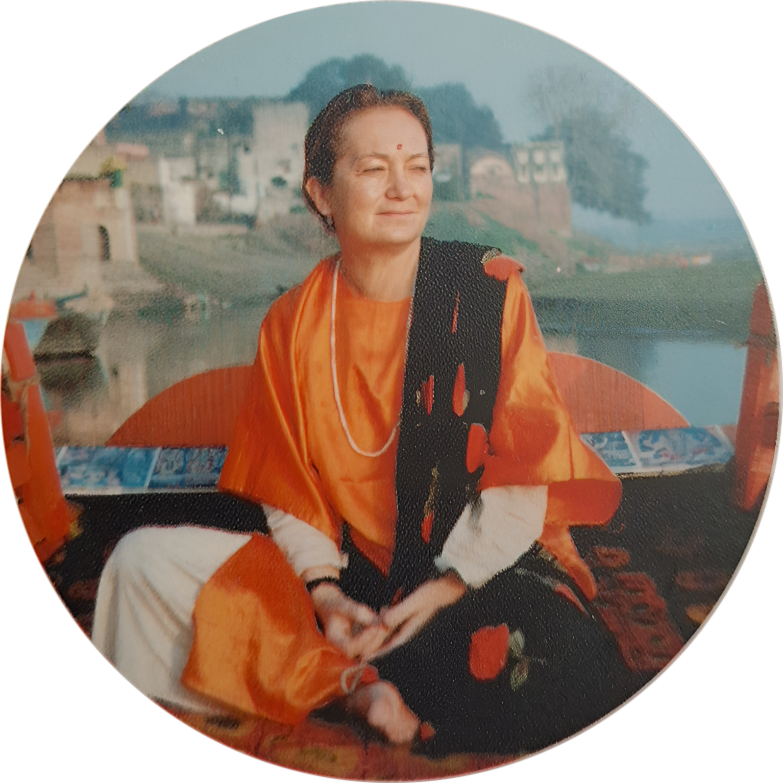 Rozália Hummel (Radhika Priya) in India, wearing traditional orange sari by the sacred river